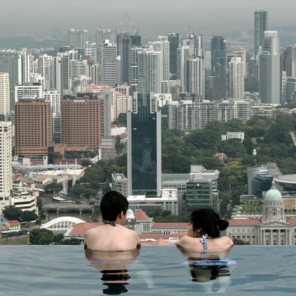 The Singapore government began to introduce residential property curbs in 2009 with some of the strictest measures implemented in 2013, including a cap on debt at 60 per cent of a borrower's income, higher stamp duties on home purchases and an increase in real estate taxes. Photo: AFP