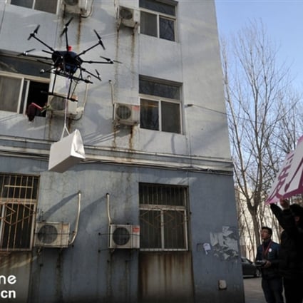 The would-be Chinese 'Romeo' flies a drone carrying a luxury bag up to the window of his 'Juliet', as his friends hold up a sign declaring his love.  Photo: cri.cn