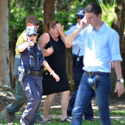 Police comfort a distressed woman at the scene where eight children were found dead. Photo: AFP