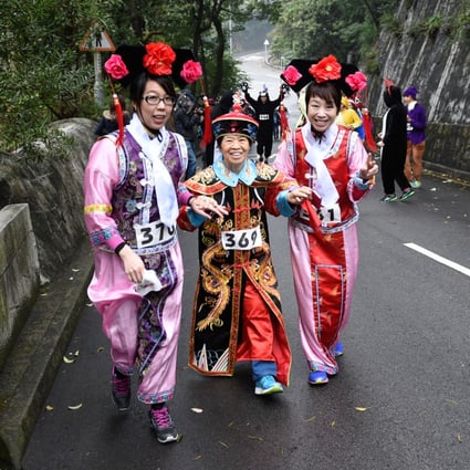 Runners dressed in traditional Chinese attire compete in Friday's run at Wan Chai Gap. Photo: Richard Castka