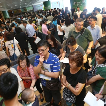Potential buyers at a residential sales event. Property prices are seen falling in the event of interest rate rises. Photo: David Wong