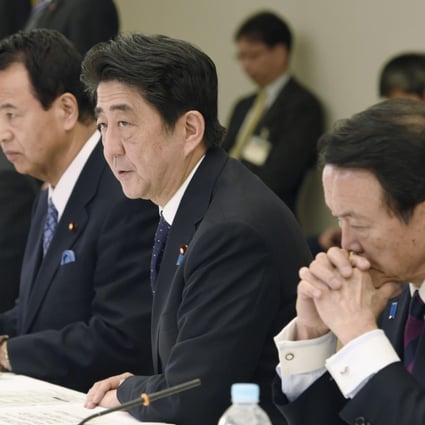 Shinzo Abe approving the stimulus plan yesterday. Photo: Kyodo
