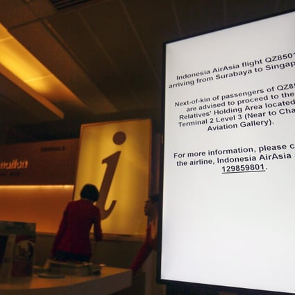 A sign directs relatives of passengers on the missing AirAsia flight to a holding area at the Changi Airport in Singapore. Photo: EPA