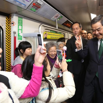 Chief Executive Leung Chun-ying (right) takes a ride on the MTR's new Island Line extension, which opens today, a victory in a hard year for the railway. Photo: Sam Tsang