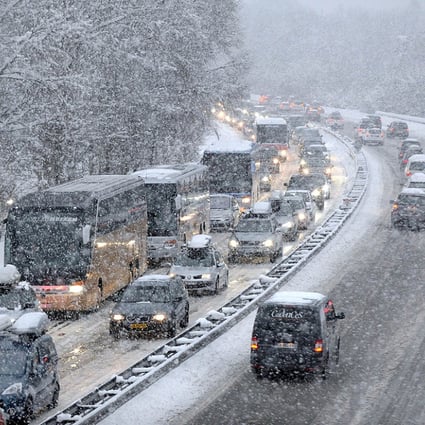 Snow falls as vehicles move bumper-to-bumper on Saturday as they make their way into the Tarentaise Valley in the heart of the French Alps. Photo: AFP