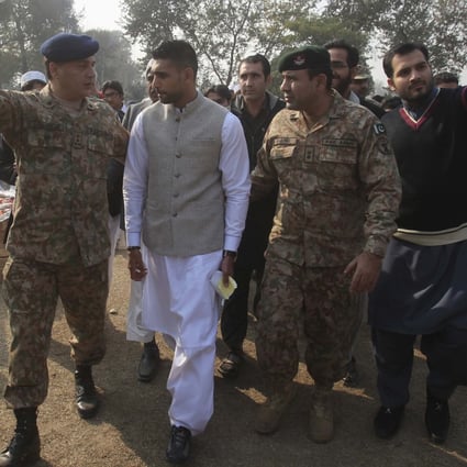 British boxer Amir Khan arrives at Army Public School, which was attacked by Taliban gunmen on December 16 in Peshawar. Photo: Reuters