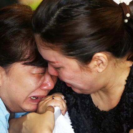 Bracing for the worst, a relative of a QZ 8501 passenger weeps at the Surabaya airport as the second day of search operations for the missing jet yields little answers. Photo: Reuters
