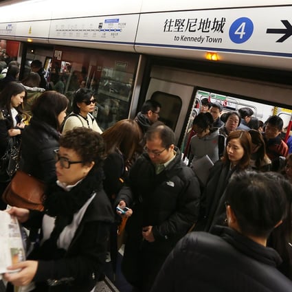 Passengers depart a train at Central station on Monday as the West Island Line experienced its first rush hour. Photo: Nora Tam