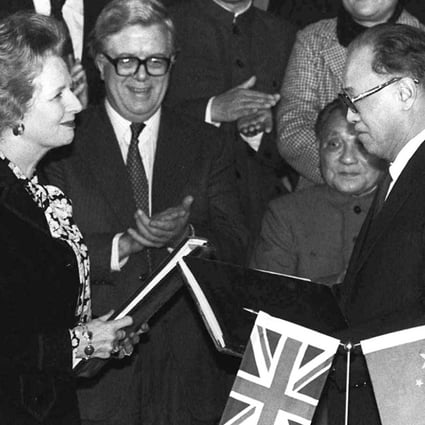 Margaret Thatcher and then premier Zhao Ziyang exchange signed copies of the Hong Kong handover agreement in Beijing in December 1984. Photo: AP