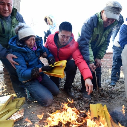 The parents of Huugjilt mourn at his graveside in Hohhot after he was cleared of murder earlier in December. Photo: Xinhua