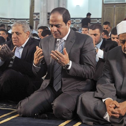 Egypt's President Abdel-Fattah el-Sisi (centre), the Grand Sheik of Al-Azhar, Ahmed el-Tayeb, (right) and Prime Minister Ibrahim Mehleb, (left) pray on the first day of Eid ul-Fitr in this file picture from October. Photo: AP