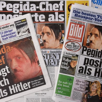 Newspapers show the picture of Lutz Bachmann posing as Adolf Hitler. Photo: EPA