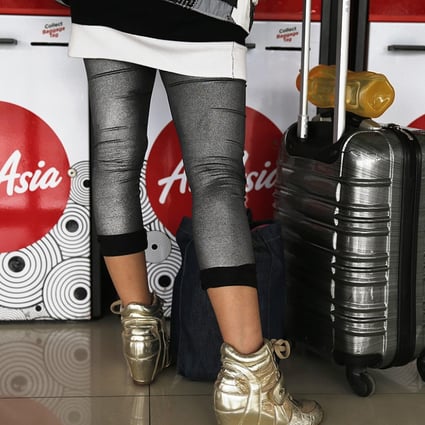 A passenger stands in front of an AirAsia check-in machine at Soekarno-Hatta airport in Jakarta on Wednesday. Photo: Reuters
