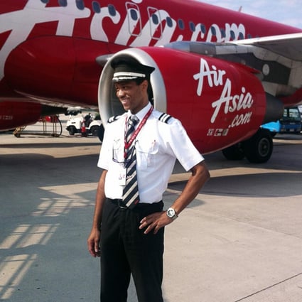Co-pilot Remi Plesel in front of an AirAsia plane. Photo: AFP