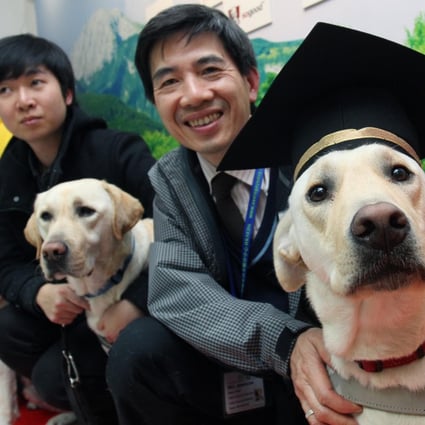 Guide dog users with their dogs - (from left) Google, Range and Walker - yesterday as they 'graduate' from the new centre. Photo: May Tse