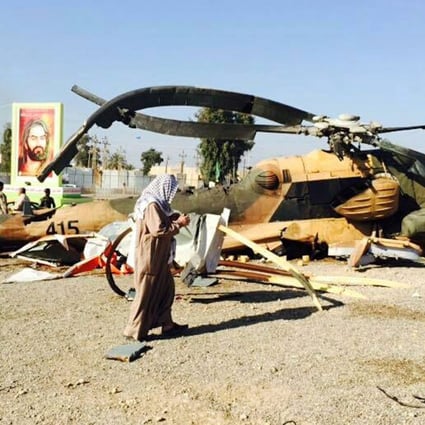 Iraqi soldiers inspect a military helicopter brought down by Islamic State militia. A Chinese envoy said last July about 100 militants from China were in Syria and Iraq to train with Islamist forces and some had stayed on to fight. Photo: EPA