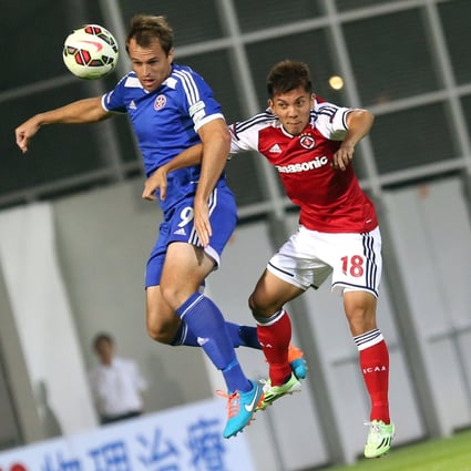 Eastern's Dylan Macallister (in blue) and South China's Kwok Kin-pong go for a header in a Hong Kong Premier League match at Mong Kok Stadium. Photo: Nora Tam