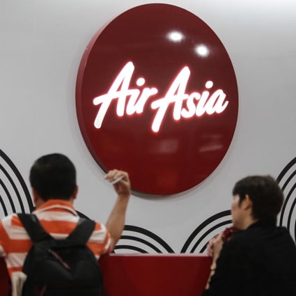 Travellers wait at AirAsia sales counter. Photo: AP