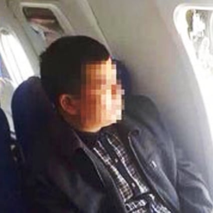 An image taken by a passenger of the man sitting in his seat after opening the aircraft's emergency exit on Monday. Photo: SCMP Pictures

