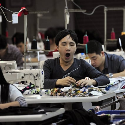 An employee yawns at a garment factory in Humen township, Guangdong province. Photo: Reuters