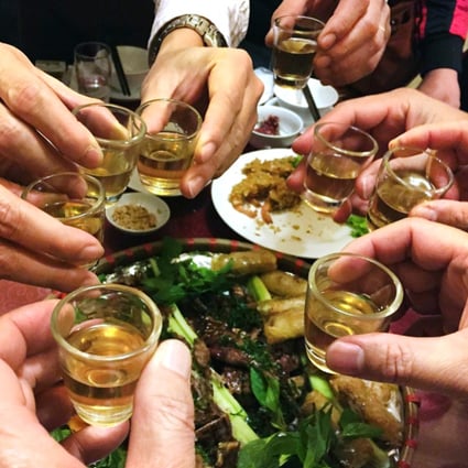 Revellers toast with rice wine at a restaurant in Hanoi. Photo: AFP