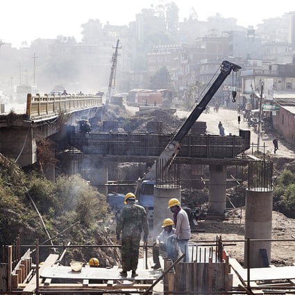 A Chinese supervisor (left) and local workers labor on a construction site at a ring road being upgraded to an eight-lane highway in Kathmandu, Nepal. Photo: Bloomberg