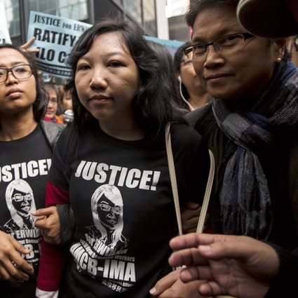 Erwiana Sulistyaningsih, centre, with supporters outside the District Court in Wan Chai yesterday. Photo: Reuters