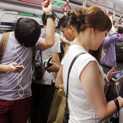 The MTR Corp worries that passengers checking their phones are not paying adequate attention to safety concerns. Photo: Dickson Lee