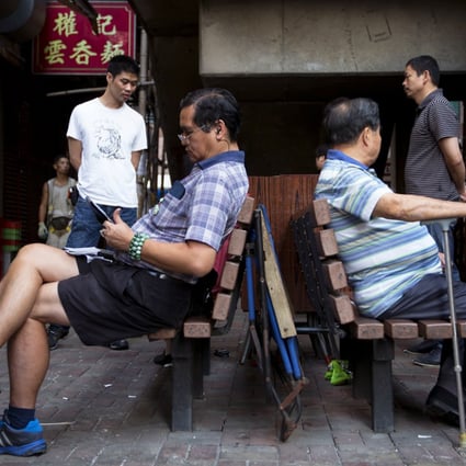 Men sit on a bench in North Point. The fund will be set up this year to cope with structural deficits likely to emerge within a decade amid an ageing population and a shrinking workforce. Photo: Bloomberg