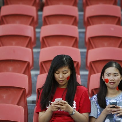 Two Chinese women read on their phones. Online and mobile publishing is big business in China. Photo: Reuters