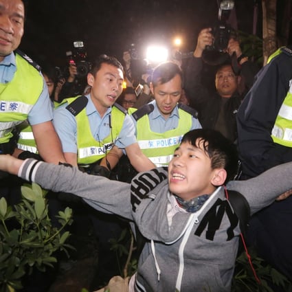 Police arrest a protester during a rally against parallel trading outside the Tuen Mun West Railway MTR station. Photo: Felix Wong