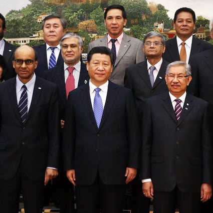 China's President Xi Jinping (front center) poses for photos with guests at the Asian Infrastructure Investment Bank launch ceremony at the Great Hall of the People in Beijing on October 24, 2014. Photo: Reuters