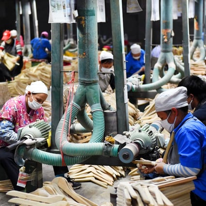 Workers making clothes hangers at a factory in the Guangxi region of southern China. The nation's economy recorded its lowest rate of growth in 24 years in 2014. Photo: Xinhua