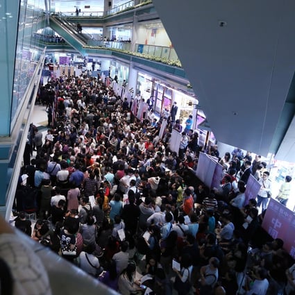 Thousands cram into Fortune Metropolis building in Hung Hom yesterday in a bid to buy a unit. Photo: Jonathan Wong