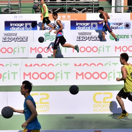 Participants race towards the basket to help beat the Guinness world record for basketball lay-ups in Southorn Playground, Wan Chai, yesterday. Photo: Franke Tsang