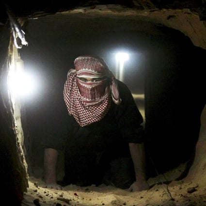 A Palestinian smuggler cleaning a destroyed tunnel that runs under the border between Egypt and the southern Gaza Strip. Photo: EPA