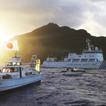The large Chinese marine surveillance ship Haijian 51 sails through smaller Japanese coast guard vessels off disputed islands in the East China Sea in July, 2013. Photo: Kyodo/Reuters