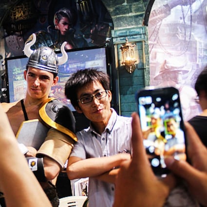 Gaming fans pose for photos at a convention in Shanghai. China had 383 million mobile gamers last year. Photo: SCMP Pictures