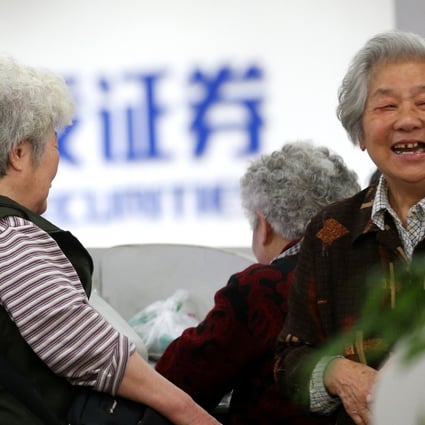 Chinese investors in a business hall in Shanghai talk about surging stock values. The government seems to have a vested interest in keeping the rally going in the markets. Photo: Xinhua