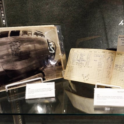 A photo of the Enola Gay and the flight logs of co-pilot Captain Robert Lewis are displayed at Bonhams auction house. Photo: AFP