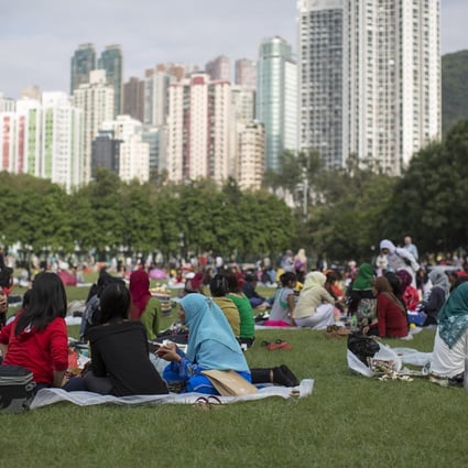 Migrant workers relax on their day off. A study has uncovered the issue of children born out of wedlock to migrant women here. Photo: Bloomberg