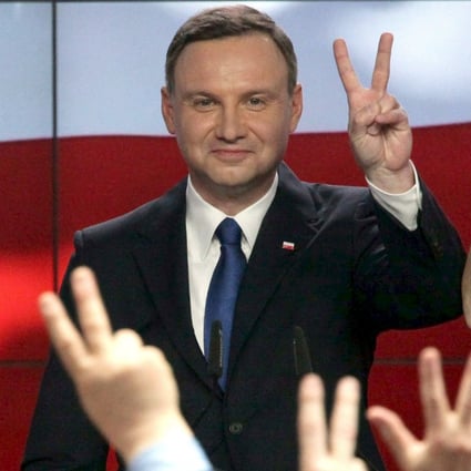 Andrzej Duda, candidate of the conservative opposition Law and Justice party, shows a victory sign after the announcement of the first exit polls in the first round of the Polish presidential elections on Sunday. Photo: Reuters