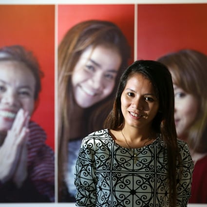 Srey Ra, pictured in front of the portraits at the Women Who Shine X Hagar exhibition. Photo: Nora Tam