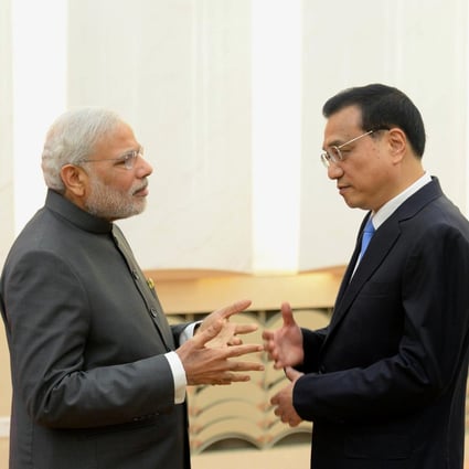 Chinese Premier Li Keqiang (right) chats with his Indian counterpart Narendra Modi after a joint press conference at Beijing's Great Hall of the People. Photo: Kyodo