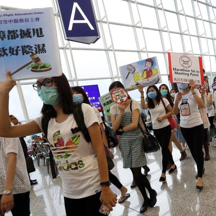 Cathay Pacific flight attendants continued their march and sit-in protest at Chek Lap Kok airport yesterday. The dispute revolves around pay, allowances and legal protection. Photo: Felix Wong