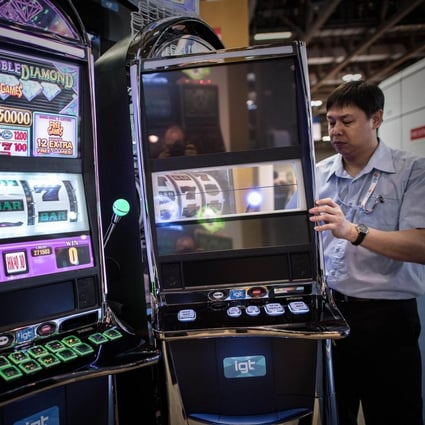 A technician checks slot machines at The Venetian in Macau. The machines have become dominant in casinos over the years. Photo: AFP