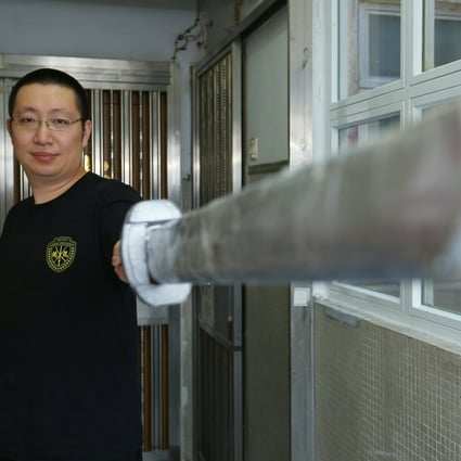 Lancelot Chan, a sword-fighting master in Hong Kong, poses with one of his replica weapons in Prince Edward. Photo: Edmond So