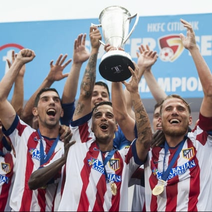 Atletico players celebrate with the trophy after beating West Ham in extra time in the HKFC Citibank Sevens final. Photo: Power Sport Images