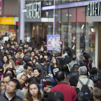 A bustling shopping street in Hong Kong. City residents have not taken to e-commerce with the same gusto. Photo: EPA