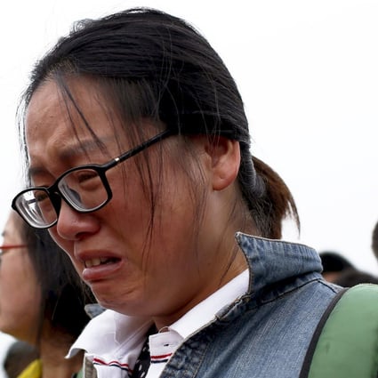 A relative of a missing passenger aboard a capsized ship cries. Photo: Reuters